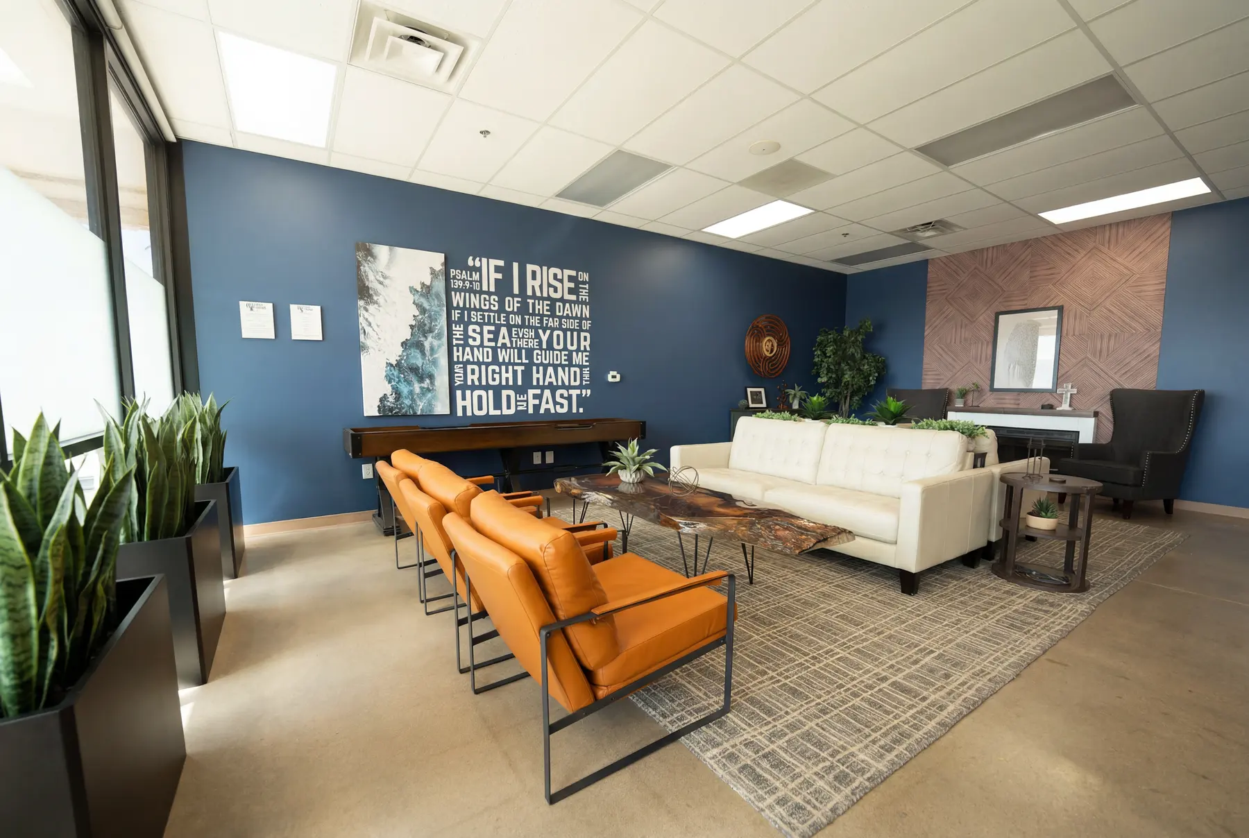 The main lounge at Holdfast Recovery, with scripture across the wall