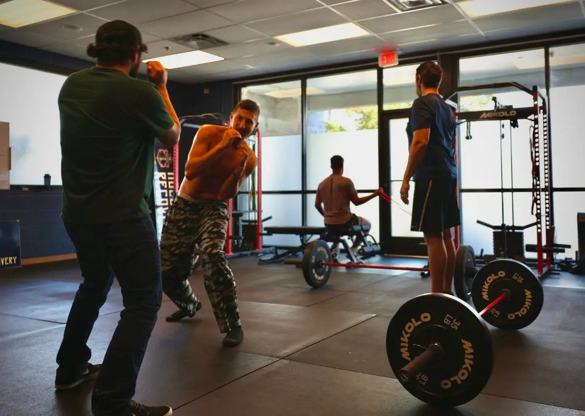 A coach working with a client in the Resilience Lab gym